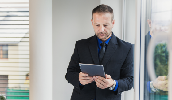 man-watching-tablet-office